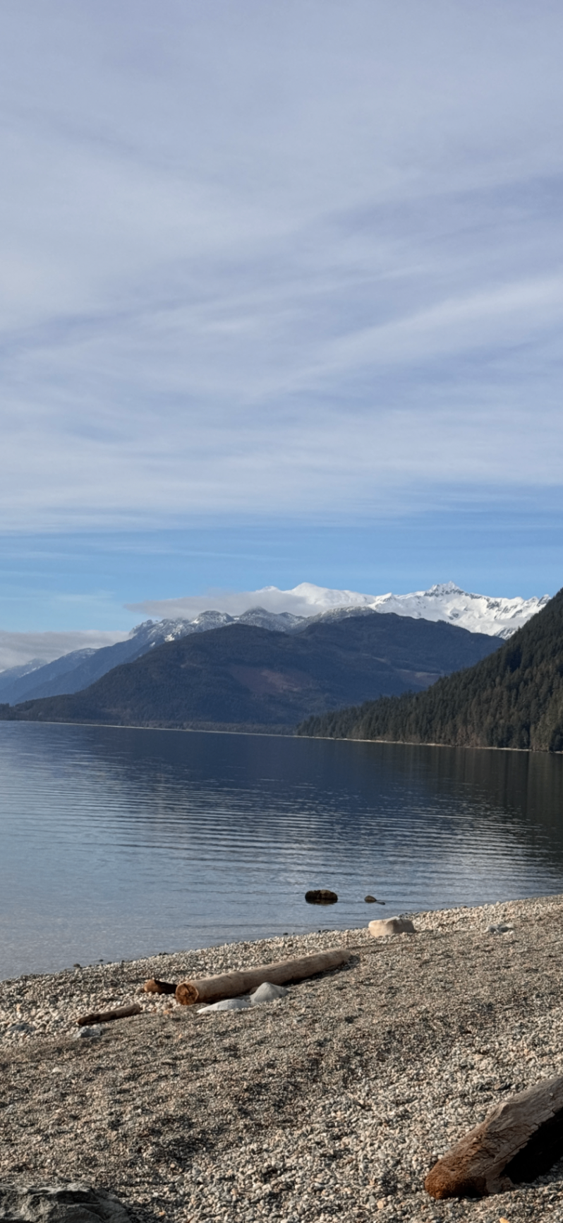 Snow-capped peaks across a calm Harrison Lake morning