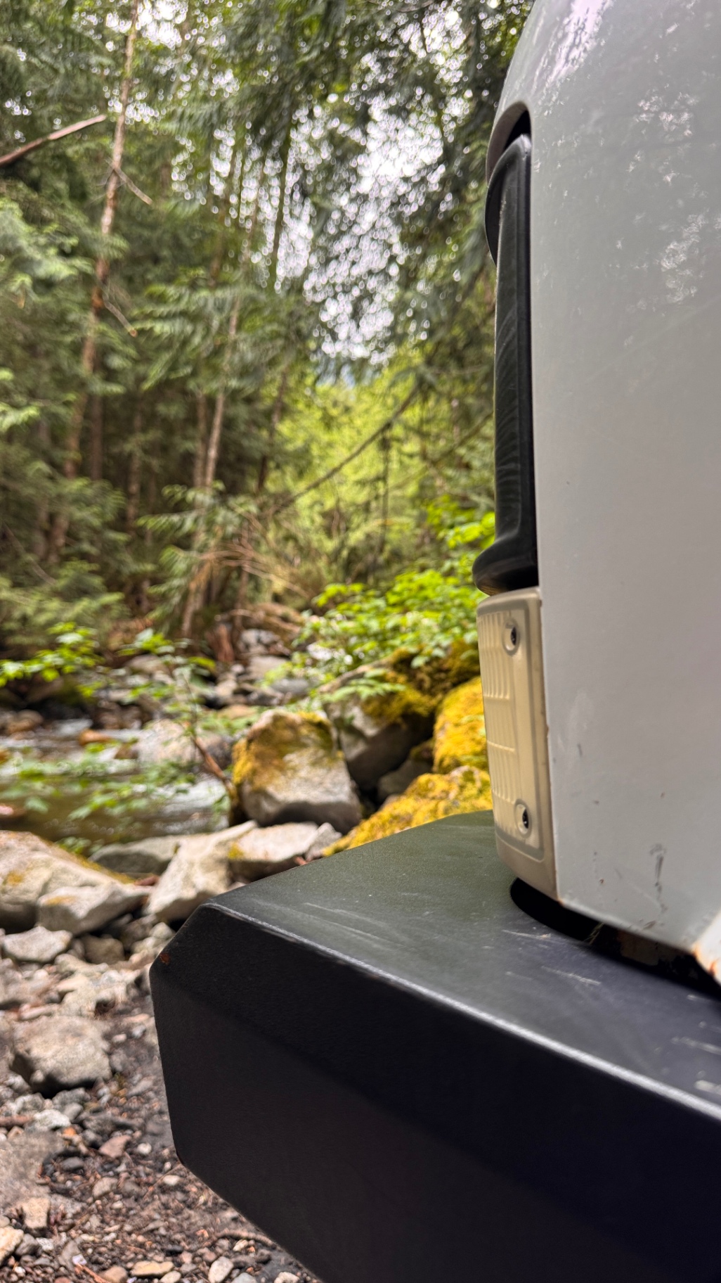 Low-angle view of the custom front bumper with the creek running in the background