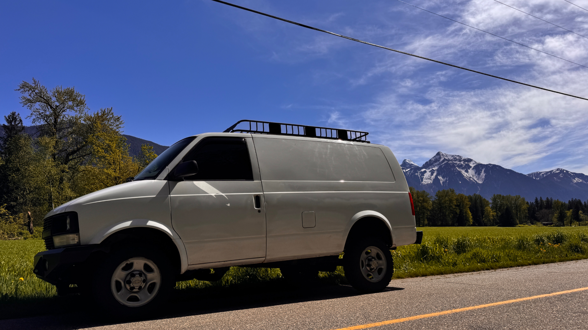 Astro side profile on the road with Mt. Cheam looming across green farmland