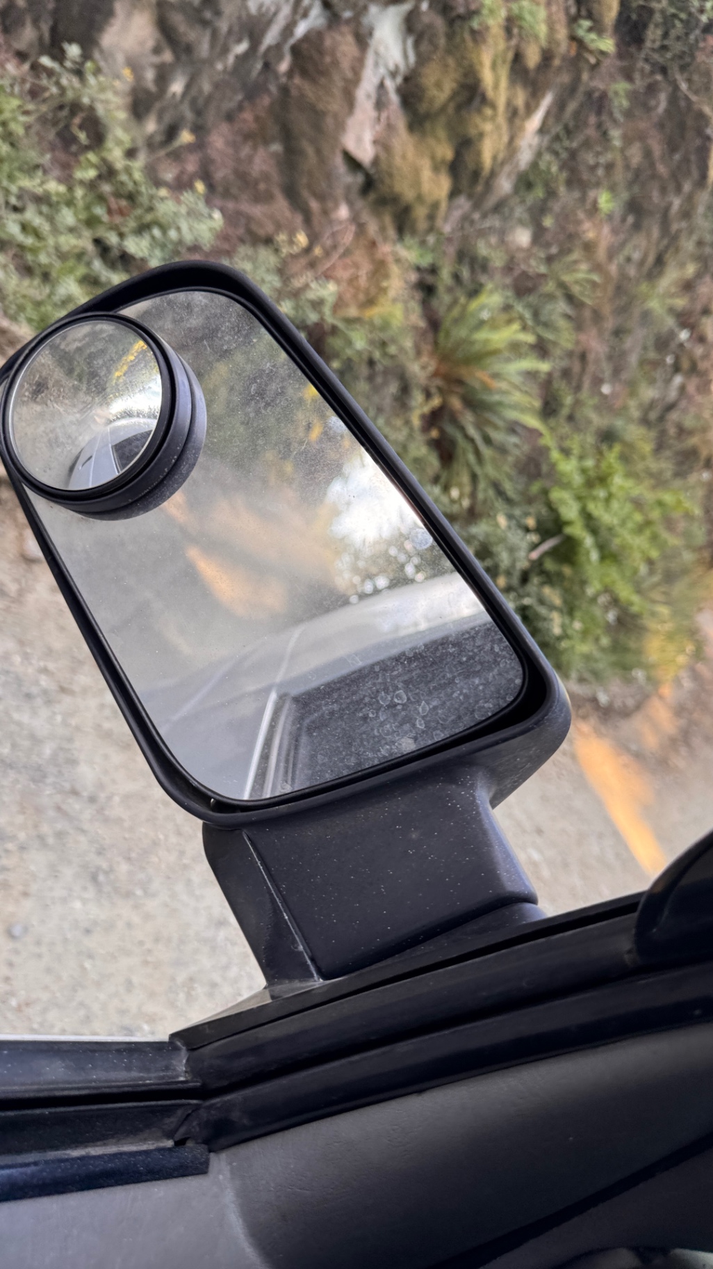 Dusty side mirror with the FSR rock wall in the background