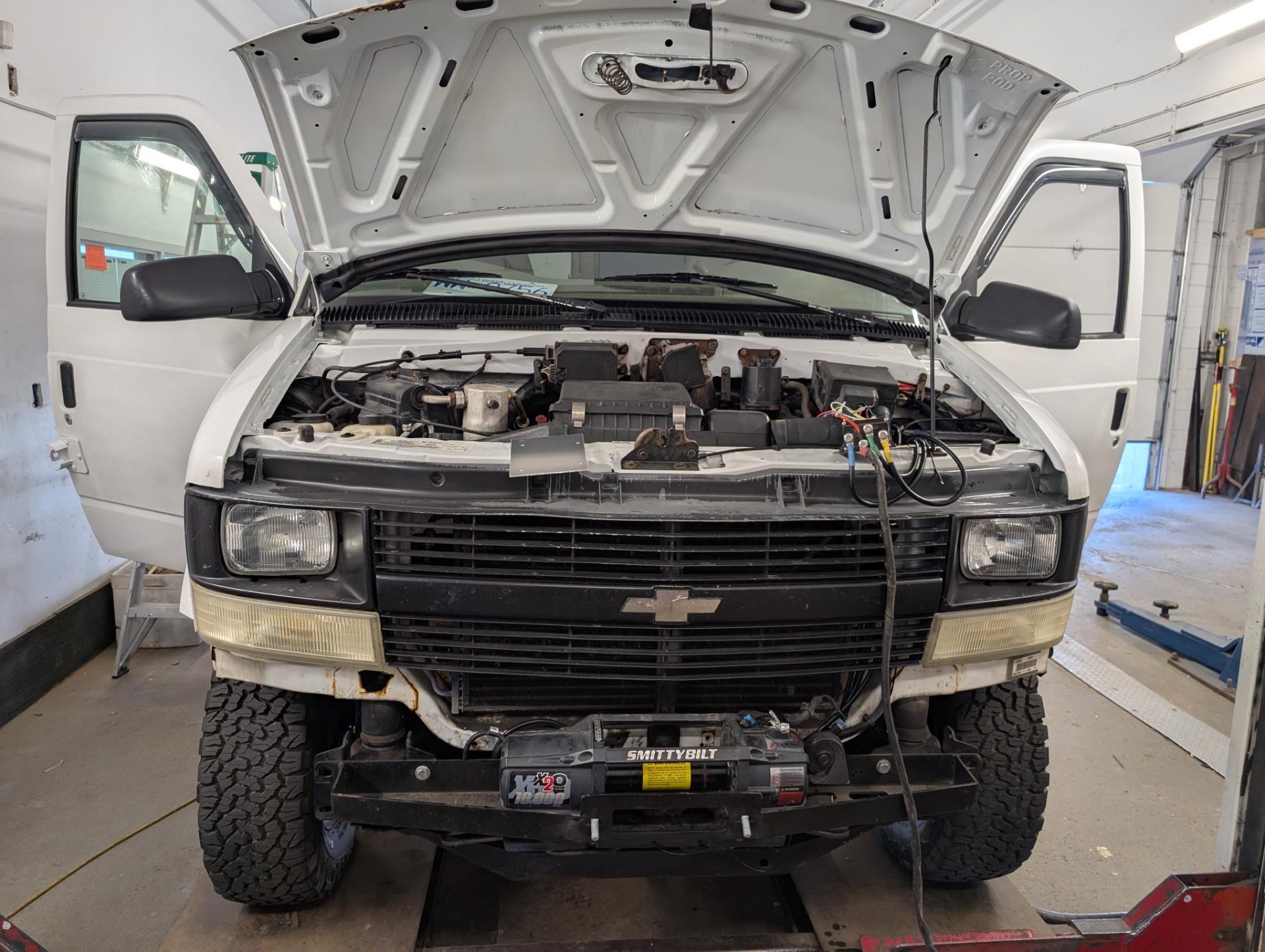 Front view of the Astro with hood up and Smittybilt X2O 10K winch visible at the front frame