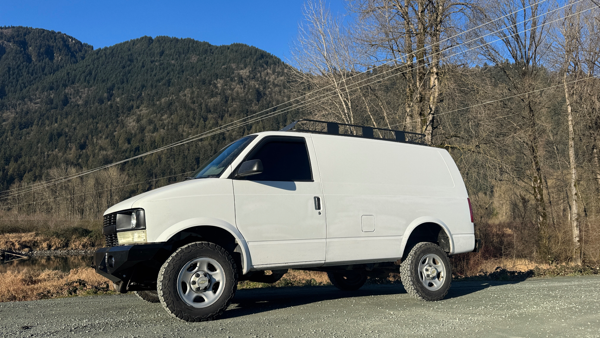 Our lifted 2005 Chevy Astro van parked on gravel in the Fraser Valley