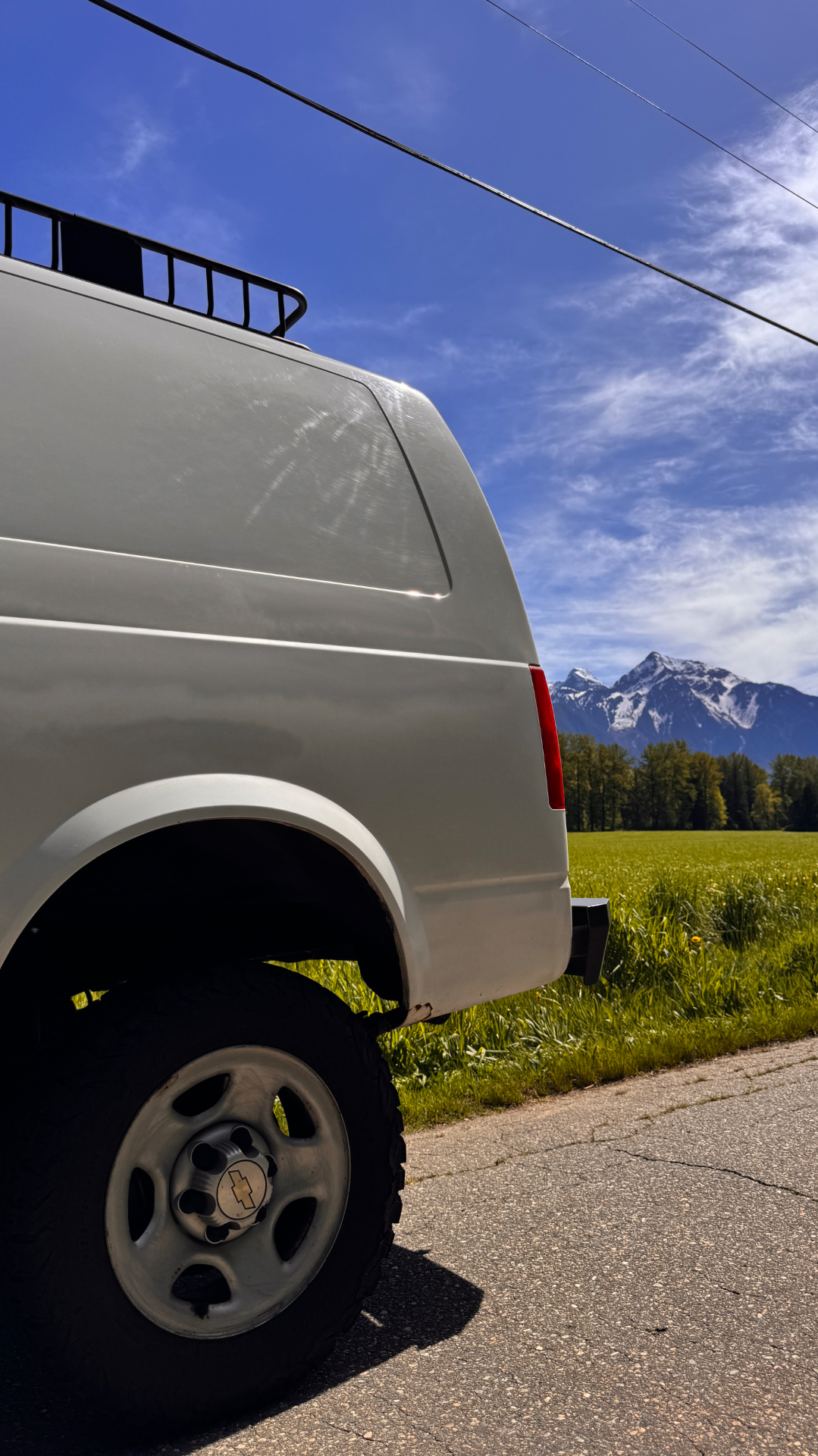 Astro rear quarter and lifted wheel with mountains across the field