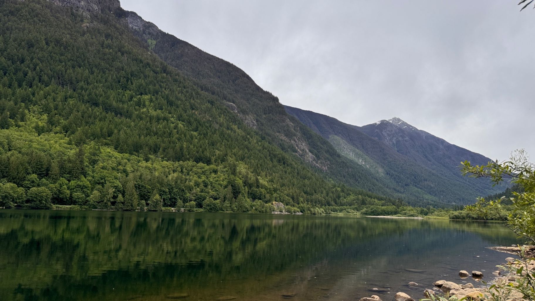 Glassy reflection of forested mountains across Silver Lake on an overcast morning